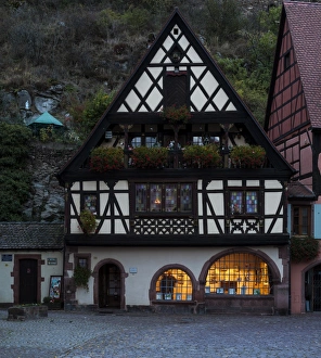 The half-timbered Maison Herzer at dusk in Kaysersberg, France The half-timbered Maison Herzer at dusk in Kaysersberg, France