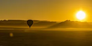A hot-air balloon at sunrise in the Namib Naukluft area of Namibia A hot-air balloon at sunrise in the Namib Naukluft area of Namibia