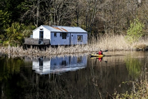A kayaker on the Crinan Canal, Argyll & Bute, Scotland A kayaker on the Crinan Canal, Argyll & Bute, Scotland