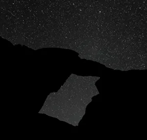 A night-time picture of a natural arch at Wadi Rum, Jordan A night-time picture of a natural arch at Wadi Rum, Jordan