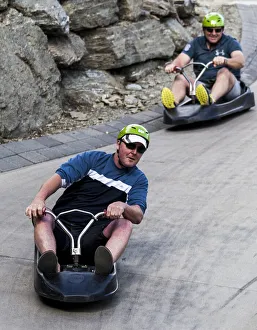 Two riders on the luge at Queenstown in Otago, New Zealand Two riders on the luge at Queenstown in Otago, New Zealand