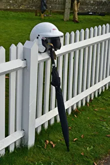 CM32 0366 Racing helmet and umbrella against the fence CM32 0366 Racing helmet and umbrella against the fence