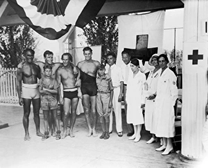 <b class=qtipBold><figcaption>1932 Olympic Swimming Tryouts</figcaption></b><br>Cincinnati, Ohio: July, 1932 At the Olympic tryouts are, left to right: Duke F. Kahanamoku, Clarence 'Buster' Crabbe, Harold 'Stubby' Kruger, Johnny Weissmueler, Judge Elmer F. Hunsicker, Paul Goss, Mrs. Mabel Fitzmorris, Mrs. Ella Layne Brown, and Mrs. Carolyn Wayman. Two boy scout messengers stand in front.<br><em>© Underwood Archives/UIG</em> 1932 Olympic Swimming Tryouts