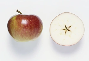 Half An Apple On Red Background Framed Photos Wall Art