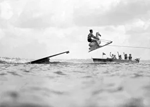 <b class=qtipBold><figcaption>Aquaplane Champ And His Horse</figcaption></b><br>Long Island, New York: c.1929. Dick Pope, famous aquaplane champion, plays 'horsey' in front of an admiring boatload of beauties on Manhasset Bay.<br><em>© Underwood Archives/UIG</em> Aquaplane Champ And His Horse