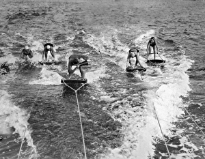 <b class=qtipBold><figcaption>An Aquaplane Teacher</figcaption></b><br>Catalina Island, California: c. 1927. An aquaplane teacher shouts through a megaphone telling his students how to achieve the upright position.<br><em>© Underwood Archives/UIG</em> An Aquaplane Teacher