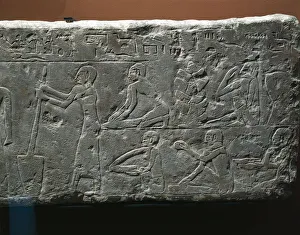 Bas-relief depicting bakers shop, woman grinding wheat and workers kneading flour Bas-relief depicting bakers shop, woman grinding wheat and workers kneading flour