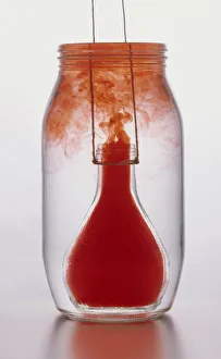 Bottle containing hot water (coloured red), lowered into jar of cold water Bottle containing hot water (coloured red), lowered into jar of cold water