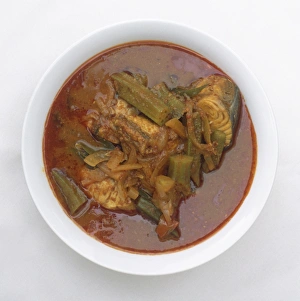 Bowl of Assam Pedas, a Malay dish of fish, brinjal and okra in tamarind-based sauce Bowl of Assam Pedas, a Malay dish of fish, brinjal and okra in tamarind-based sauce