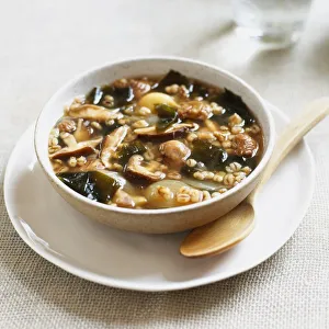 Bowl of soup containing barley, chestnuts, shiitake mushrooms, onions and wakame seaweed Bowl of soup containing barley, chestnuts, shiitake mushrooms, onions and wakame seaweed