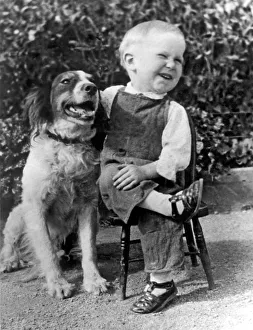 <b class=qtipBold><figcaption>A Boy Laughs With His Dog</figcaption></b><br>Butte, Montana: c. 1930. A youngster, who likes to sit the way his daddy does, enjoys a joke with his best friend.<br><em>© Underwood Archives/UIG</em> A Boy Laughs With His Dog