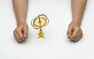 <b class=qtipBold><figcaption>Boy's hands around toy gyroscope</figcaption></b><br><em>© Dorling Kindersley/UIG</em> Boy's hands around toy gyroscope