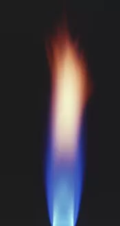Bright blue and orange flame of bunsen burner, close up