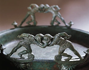 Bronze vessel with handles in shape of two pairs of fighting warriors from the necropolis Bronze vessel with handles in shape of two pairs of fighting warriors from the necropolis