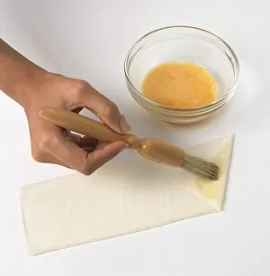 Basting Brush Gallery: Brushing egg yolk on folded edge of samosa pastry