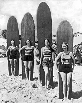 <b class=qtipBold><figcaption>California Surfer Girls</figcaption></b><br>Southern California: c. 1930. Six young women are ready with their surf boards on a beach in southern California.<br><em>© Underwood Archives/UIG</em> California Surfer Girls