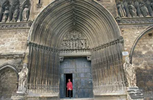 Camino of Santiago pilgrim walking out of Santo Sepulcro church in Estella Camino of Santiago pilgrim walking out of Santo Sepulcro church in Estella