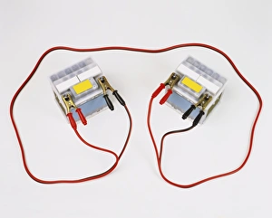Two car batteries attached by jump leads Two car batteries attached by jump leads