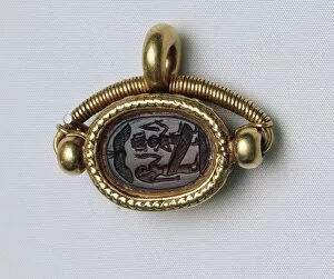 Carnelian scarab with Isis and Horus as child, set in gold