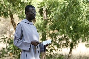 Catholic friar holding rosary and prayer book Catholic friar holding rosary and prayer book
