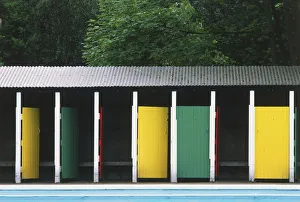 Changing rooms with brightly painted doors and corrugated iron rook, standing by an Changing rooms with brightly painted doors and corrugated iron rook, standing by an