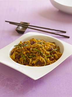Char kway teow, Singaporean stir-fried rice noodles with sausages, eggs and chives Char kway teow, Singaporean stir-fried rice noodles with sausages, eggs and chives