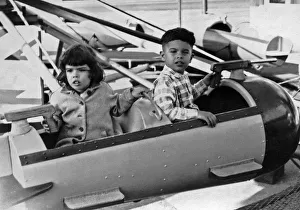 <b class=qtipBold><figcaption>Children At Playland In SF</figcaption></b><br>San Francisco, California: c. 1953 Two young children keep an eye out for invaders in their rocket car ride at Playland At The Beach<br><em>© Underwood Archives/UIG</em> Children At Playland In SF