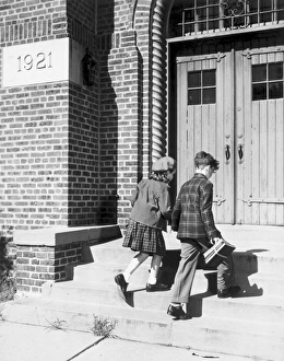 <b class=qtipBold><figcaption>Two children walking into school</figcaption></b> Two children walking into school