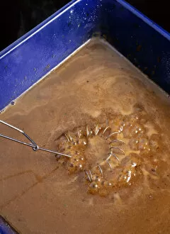 Gravy Collection: Coil whisk mixing gravy in a roasting tray