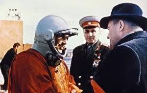 Cosmonaut yuri gagarin shaking hands with rocket designer korolev (right) at baikonur