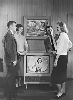 Images Dated 10th November 2003: Two couples standing next to television