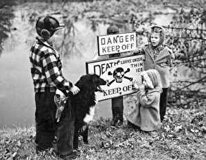 <b class=qtipBold><figcaption>'Danger, Thin Ice' Sign</figcaption></b><br>Scarsdale, New York: c. 1955. Three small children and their dog contemplate the 'Danger, Thin Ice' sign posted by a pond.<br><em>© Underwood Archives/UIG</em> 'Danger, Thin Ice' Sign