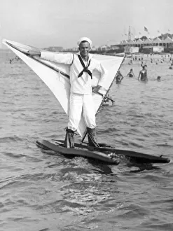 <b class=qtipBold><figcaption>Early Wind Surfer In 1926</figcaption></b><br>Ocean View, Virginia: c. 1926. A sailor from the Hamptons Roads Naval Base out for a walk on the water with his Austrian water skis and novel sail.<br><em>© Underwood Archives/UIG</em> Early Wind Surfer In 1926