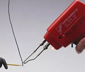 Electrical soldering iron with solder and copper wire