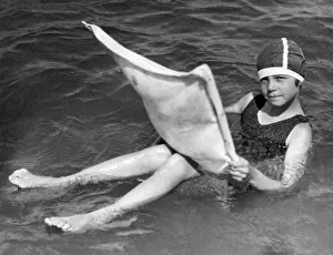 <b class=qtipBold><figcaption>Floating With New Rubber Tube</figcaption></b><br>Coronado Beach, California: November, 1922. This youngster appears to be resting on the surface of the water, but closer inspection reveals that she is supported by a special air-inflated tube that holds her up.<br><em>© Underwood Archives/UIG</em> Floating With New Rubber Tube