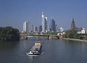 Germany, Frankfurt, the skyline of Frankfurt am Main, reminiscent of New York, with a cargo boat on the river