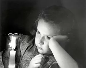 Girl looking at lighted candle