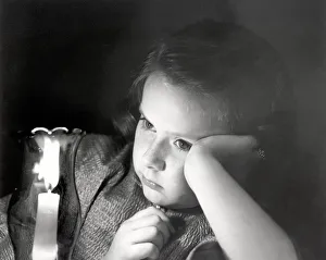<b class=qtipBold><figcaption>Girl looking at lighted candle</figcaption></b> Girl looking at lighted candle