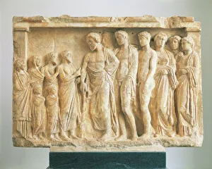 God Asclepius accompanied by his children before a family of devotees, votive marble relief God Asclepius accompanied by his children before a family of devotees, votive marble relief