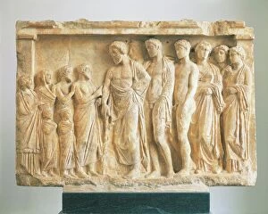 Antiquities Gallery: God Asclepius accompanied by his children before a family of devotees, votive marble relief