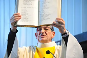Gospel held by a catholic priest in church during a celebration Gospel held by a catholic priest in church during a celebration