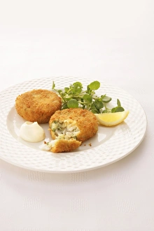 Haddock and herb fishcakes coated in breadcrumbs, served with watercress Haddock and herb fishcakes coated in breadcrumbs, served with watercress