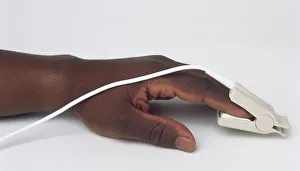 <b class=qtipBold><figcaption>Hand wearing pulse oximeter</figcaption></b><br><em>© Dorling Kindersley/UIG</em> Hand wearing pulse oximeter