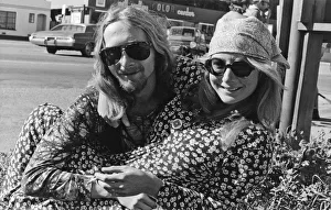 <b class=qtipBold><figcaption>A Happy Hippie Couple</figcaption></b><br>California: c. 1969 A colorful hippie couple dressed in tie-dye and floral prints grin for the camera.<br><em>© Underwood Archives/UIG</em> A Happy Hippie Couple