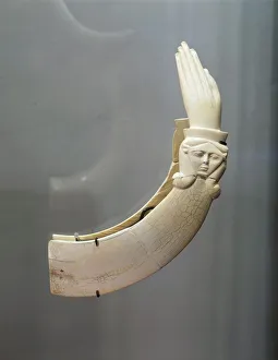Hippopotamus ivory claquettes (castanets) in the shape of hand with carving depicting Hippopotamus ivory claquettes (castanets) in the shape of hand with carving depicting