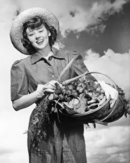 Historic portrait of woman holding a basket of fresh vegetables, black and white Historic portrait of woman holding a basket of fresh vegetables, black and white