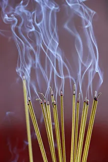 Incense sticks on joss stick pot are burning and smoke use for pay respect to the Buddha Incense sticks on joss stick pot are burning and smoke use for pay respect to the Buddha