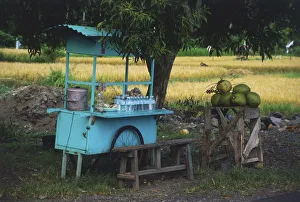 Indonesia, East Bali, near Candi Dasa, road-side food stall selling water and fruit Indonesia, East Bali, near Candi Dasa, road-side food stall selling water and fruit