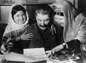 Joseph stalin with two young women collective farm workers from tadjikistan soviet Joseph stalin with two young women collective farm workers from tadjikistan soviet