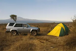 Kenya, near Amboseli National Park, Satao Elerai Camp, tent and van with Mount Kilimanjaro in the distance Kenya, near Amboseli National Park, Satao Elerai Camp, tent and van with Mount Kilimanjaro in the distance
